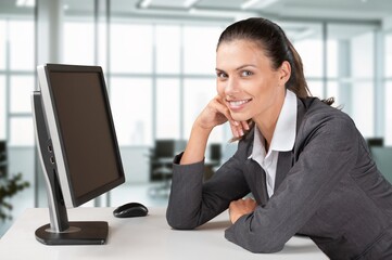Happy smiling business woman using computer