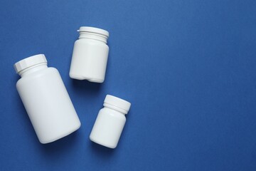 White bottles  on blue background, top view