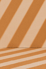 Fototapeta premium Warm diagonal stripes forming geometric shadows. Peach tones evoke calm with minimalistic, warm lighting.