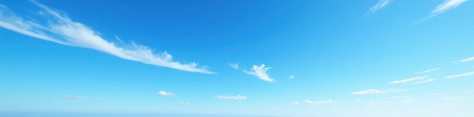 Obraz premium Serene blue sky with wispy white clouds against a bright blue horizon, blue sky, outdoor scene