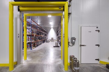 open door into insulated refrigerated room in warehouse