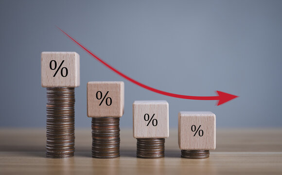 business turnover decreased, interest rate decline, Wood blocks with percentage sign and down arrow on gray background, recession crisis concept.	