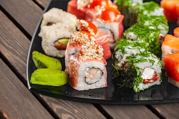 Fresh tasty sushi rolls on plate