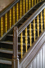 old wooden beautiful stairs in an old historical and historic residential building in the city....