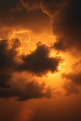 Fototapeta premium Dramatic sky filled with warm, golden light piercing through dark clouds, creating a breathtaking spectacle.