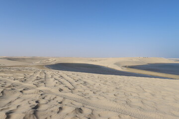 Sand dune with tire tracks in Inland Sea, Qatar