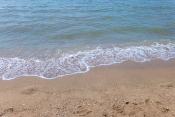 Soft blue ocean wave on clean sandy beach. Copy Space. Background