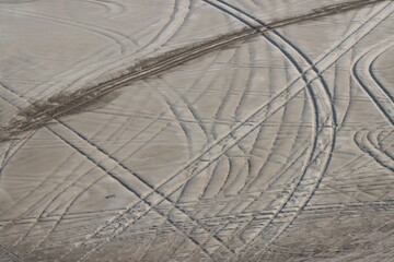 Car tracks marking the desert in Qatar