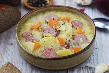 A bowl with traditional German potato soup with sausages