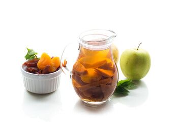 Dried fruit compote with apples and mint, isolated on white background