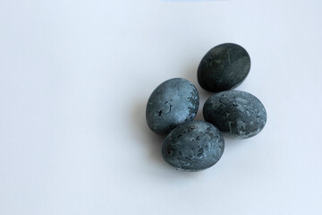 four Easter eggs painted with karkade tea