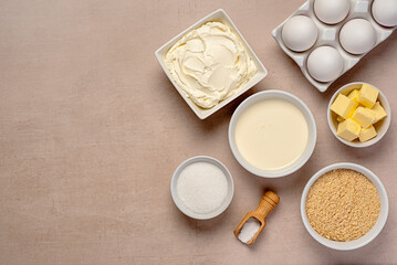 Blank food photography of raw ingredients of New York cheesecake, cream, soft cheese, sugar, butter, shortbread crumbs, vanilla