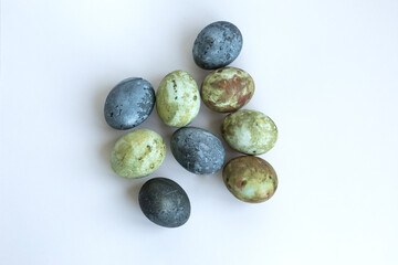 four Easter eggs painted in green-brown colors and Karkade tea