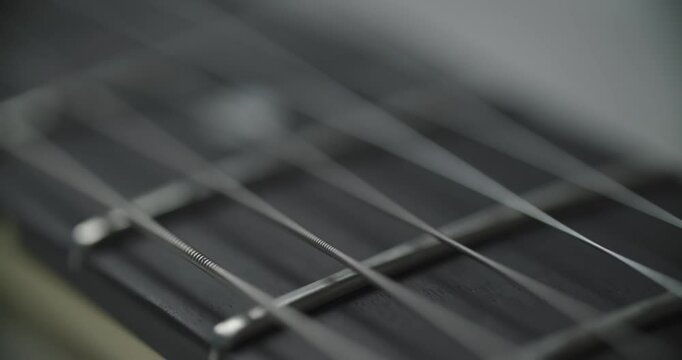 Detailed view of guitar fingerboard that beautifully showcases its frets and strings in intricate detail