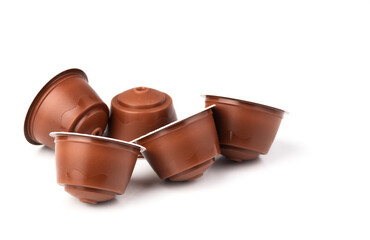 Brown coffee capsules on a white background. Plastic espresso pods for coffee machines. Isolated...