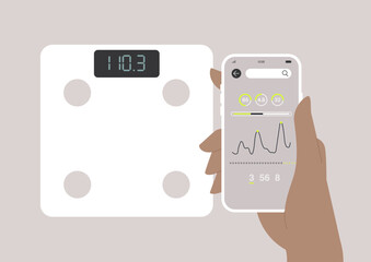 A user engages with a modern bathroom scale displaying their weight while examining data on a connected mobile application that tracks health metrics and trends over time