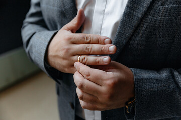 Close-up photo of the men`s holding woman hand with golden wedding ring with diamond. Wedding ring...