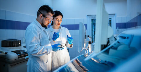 Research scientists work in a laboratory with modern equipment. Analyzes samples and genetic...