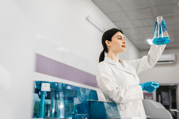A scientist uses lab equipment for an experiment, working with test tubes and samples. Concept...