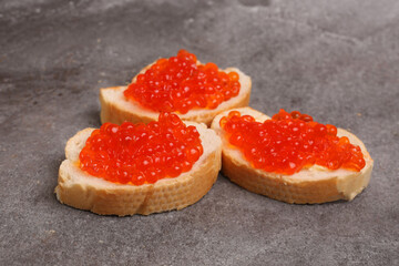 sandwiches with red caviar on a light background