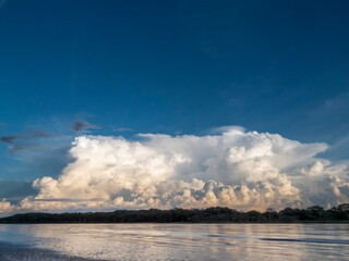 River landscape on the Amazon with an imposing cloud mountain range.