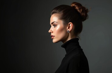 Studio fashion portrait of beautiful woman in black turtleneck. High hair beam, perfect profile face, elegant beauty style. Silver earrings in ears on dark background.