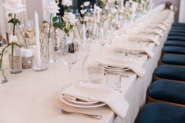 Decorated table with fresh flowers and serving with cake. Celebrating a party in a restaurant
