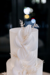 Trendy cake made of white paper. White luxury large cake for celebration in a restaurant