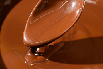 Melted dark chocolate in a spoon