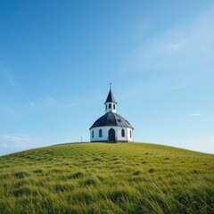 Charming Round White Chapel on Green Hill under a Clear Sky