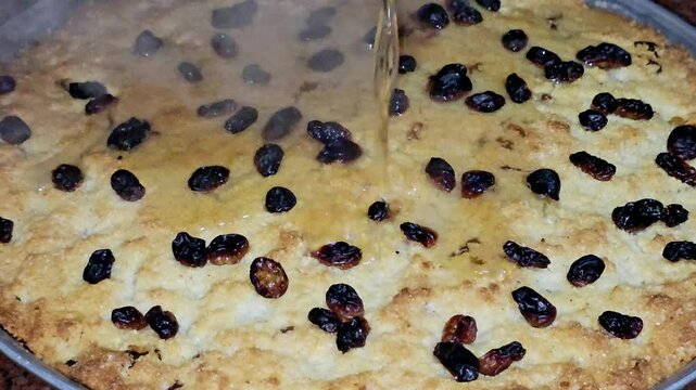 Basbosa tray topped with burnt raisins or basbusa baked in the oven, Basbusa is a middle eastern dessert that is usually baked in Ramadan month, Arabian sweet cuisine background