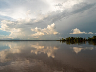 Amazon river landscape. Clouds are reflected on the huge expanse of water in the Amazon.