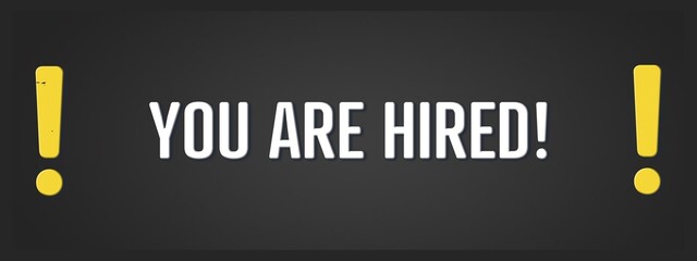 You are hired. A blackboard with white text. Illustration with grunge text style.
