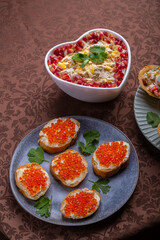 Salad with chicken, pineapple and pomegranate in a heart-shaped salad bowl