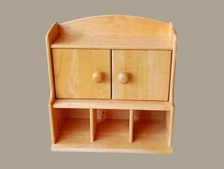 The gray background in the picture is a brown wooden wall mounted shelving unit that can be used as a multipurpose storage cabinet or medicine cabinet in the home. It has many compartments and is comp