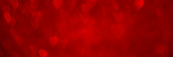 Red hearts, sparkling glitter bokeh background banner, valentines day abstract defocused texture header.