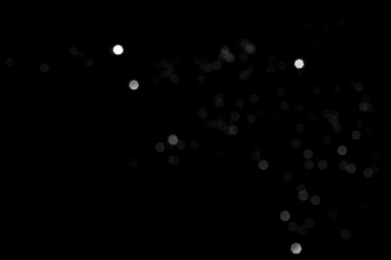White gray blurred bokeh lights on black background. Glitter sparkle stars for celebrate. Overlay for your design