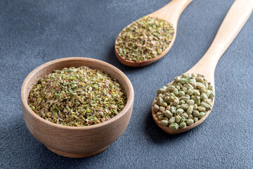 A bowl full of dried and ground natural mountain thyme on gray background.

