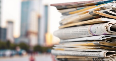 Many newspapers as background in modern office