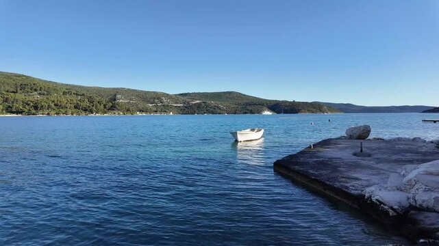 White boat on the sea water, mountains around, landscape view