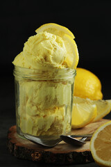 Lemon ice cream scoops in glass jar