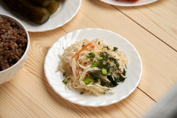 sauerkraut cabbage on a wooden background symbolizes a quiet conversation with God, which occurs through a prayer and reading a word during fasting