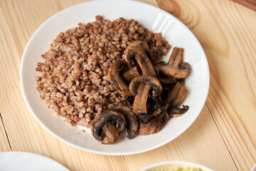 Buckwheat with mushrooms simplicity and modesty Buckwheat with mushrooms on a wooden background symbolizes simplicity and modesty, which help believers focus on spiritual life during Lent