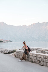 Young woman exploring a quaint European coastal town, embodying the digital nomad lifestyle and the freedom of solo travel serene moment of discovery and balance