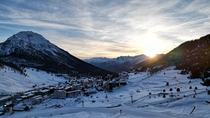 Golden sunset over snowy Alpine peaks in Montgenèvre, France
