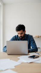 Fototapeta premium Man Working at Table with Laptop