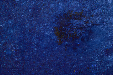 Abstract textured blue surface with brown patch
