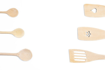 Wooden kitchen utensils arranged on a white background
