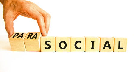 Social or parasocial symbol. Concept words Social or Parasocial on beautiful wooden blocks. Beautiful white table white background. Businessman hand. Business social parasocial concept. Copy space.