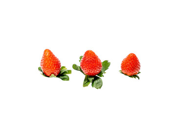 Three strawberries are on a leaf. The strawberries are red and have green leaves. The leaf is on a white background